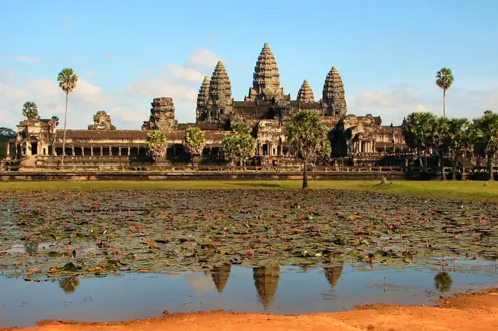 Angkor Wat reflected in water at warm light